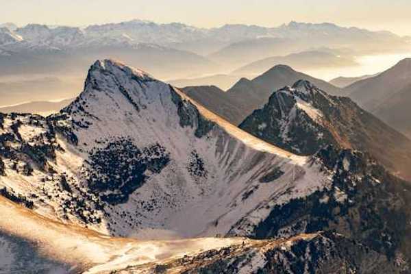 A photo of snow-capped French alps during the golden hour