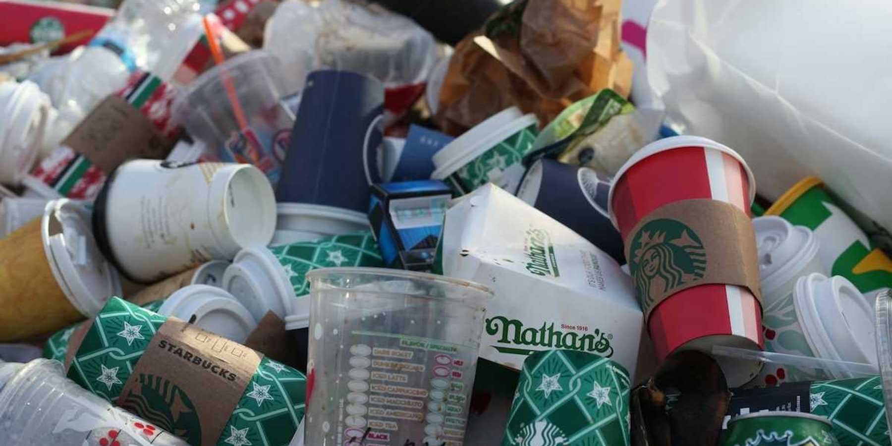 A pile of coffee-to-go cups and takeout packaging