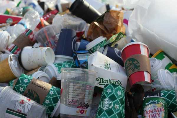 A pile of coffee-to-go cups and takeout packaging