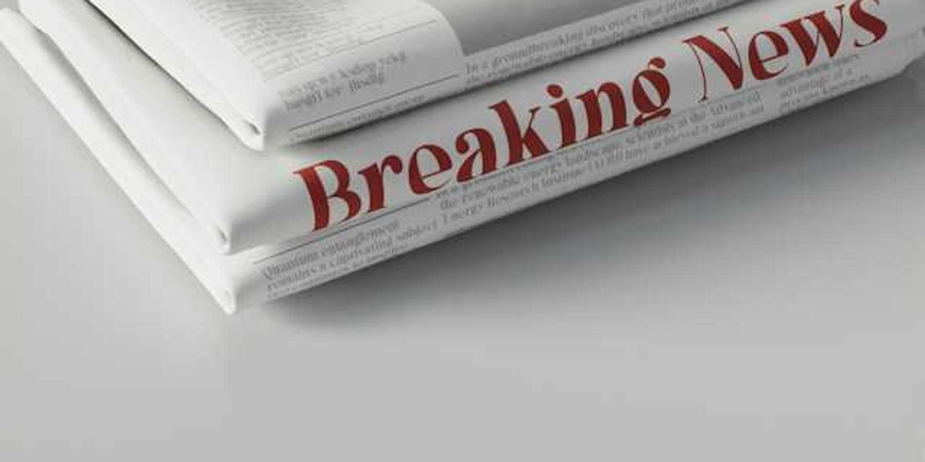 A pile of newspapers with the words Breaking News in red