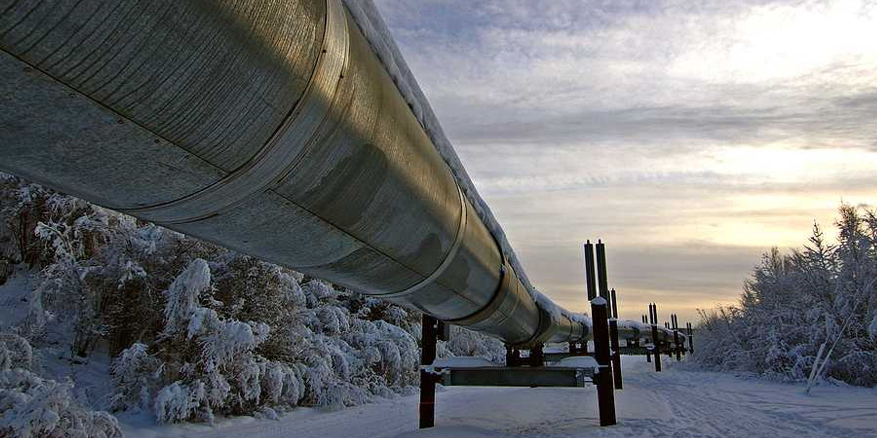 A pipeline stretching across a snowy landscape