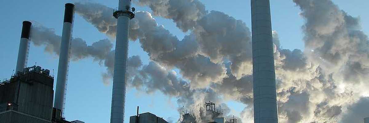A power plant's smokestacks billowing smoke into the air