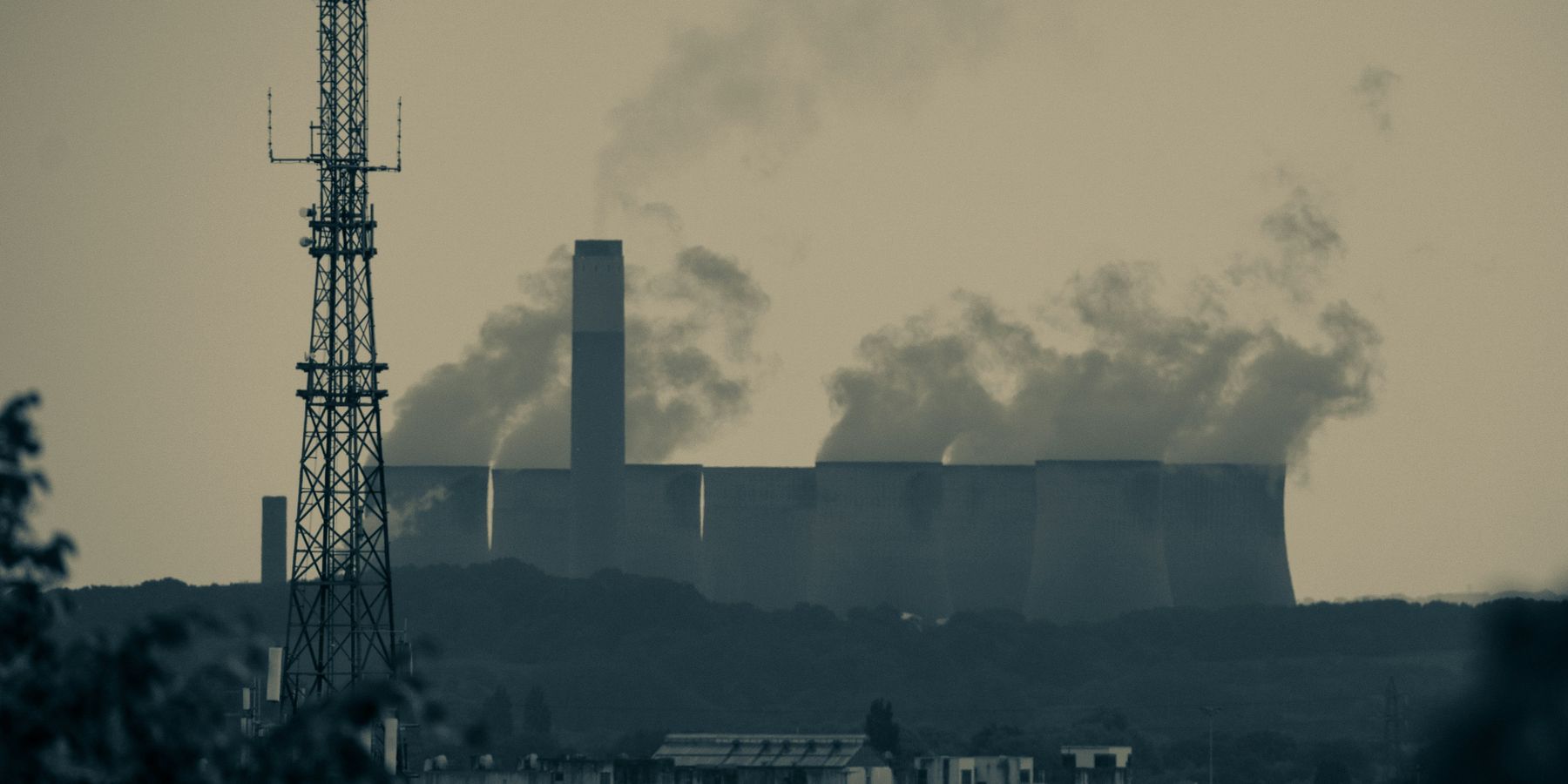 A power station with smoke billowing from towers