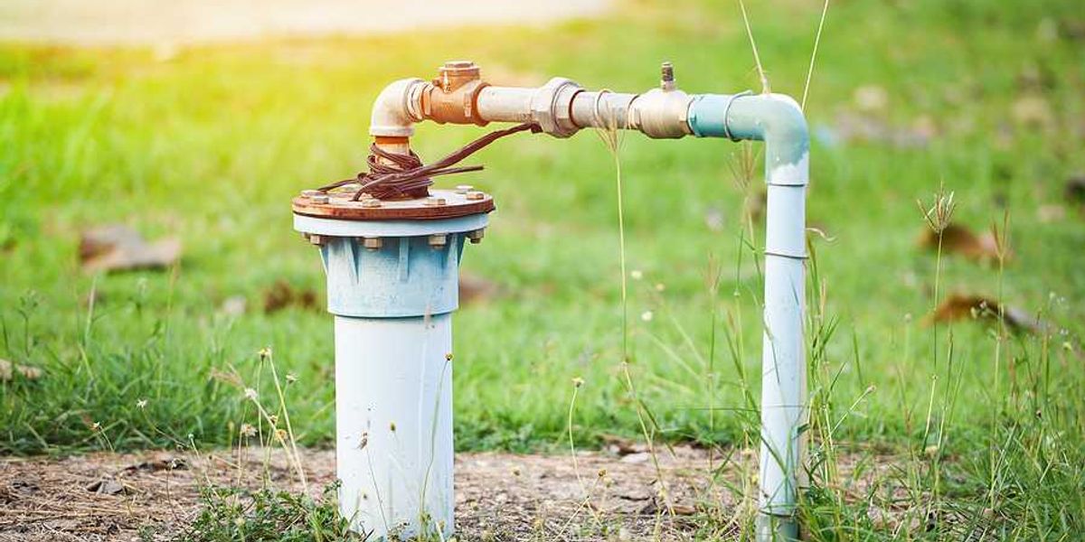 A private water well with pipes pointing into the ground