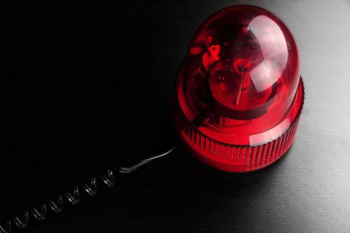 A red emergency light on a black surface