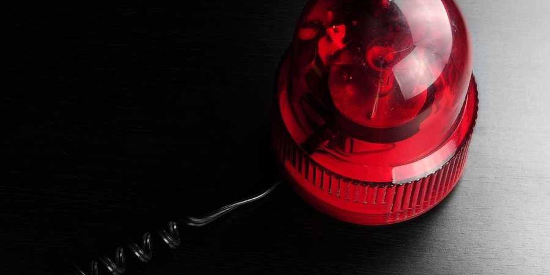 A red emergency light on a black surface