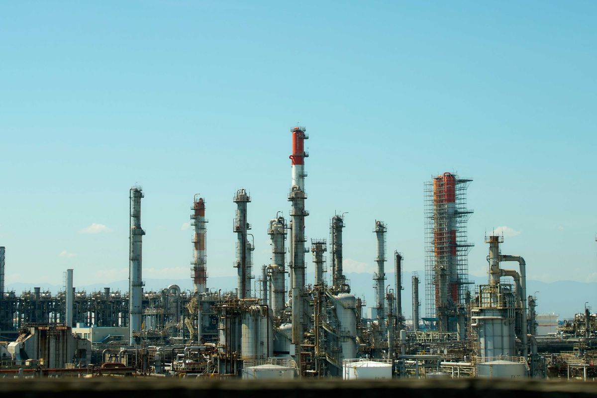 A refinery with lots of smokestacks and industrial equipment
