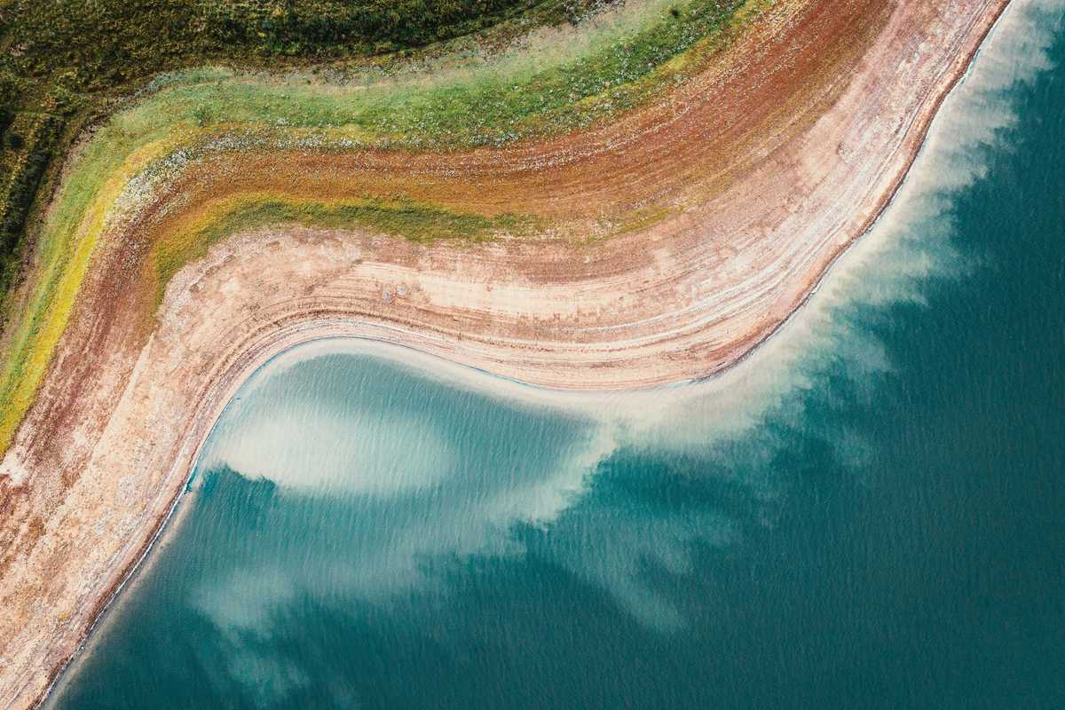 A reservoir viewed from above with dry shores