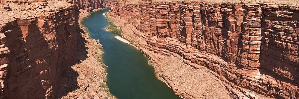 A river flowing between dry rocky bluffs
