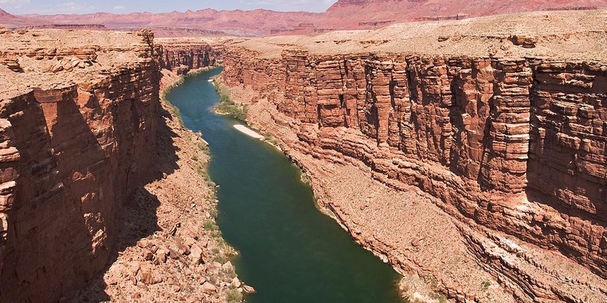 A river flowing between dry rocky bluffs