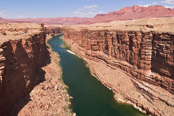 A river flowing between dry rocky bluffs