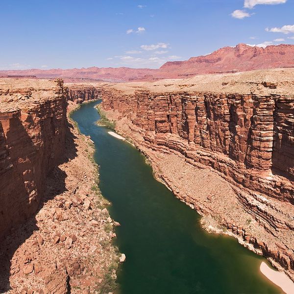 A river flowing between dry rocky bluffs