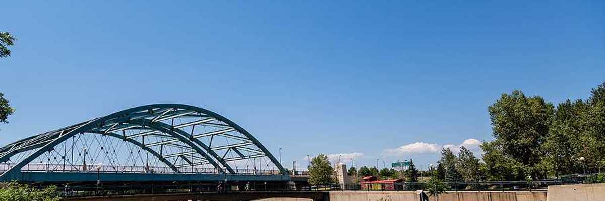 A river flowing under a steel bridge