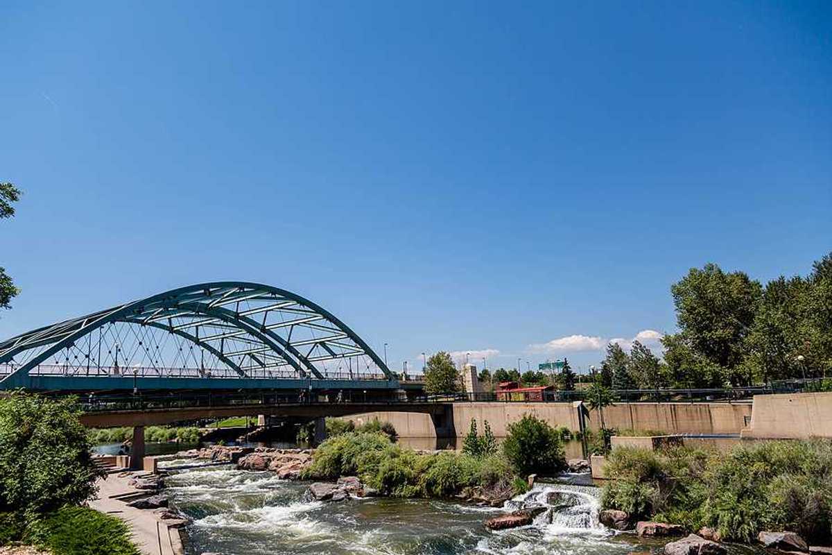 A river flowing under a steel bridge