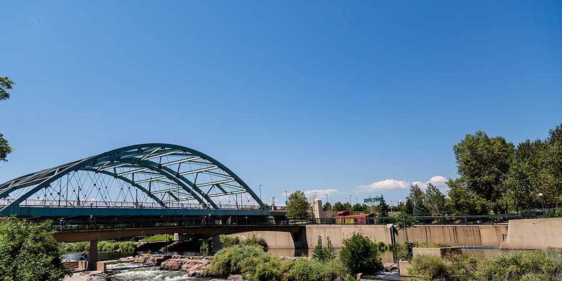 A river flowing under a steel bridge
