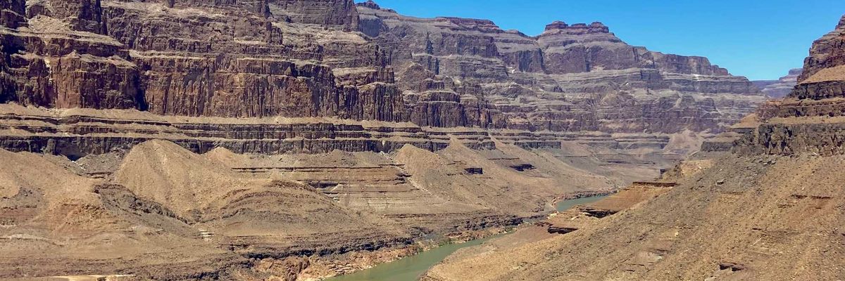 A river running through a canyon surrounded by mountains.