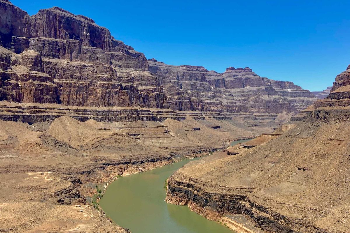 A river running through a canyon surrounded by mountains.