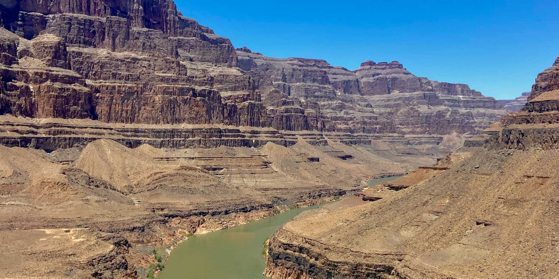 A river running through a canyon surrounded by mountains.