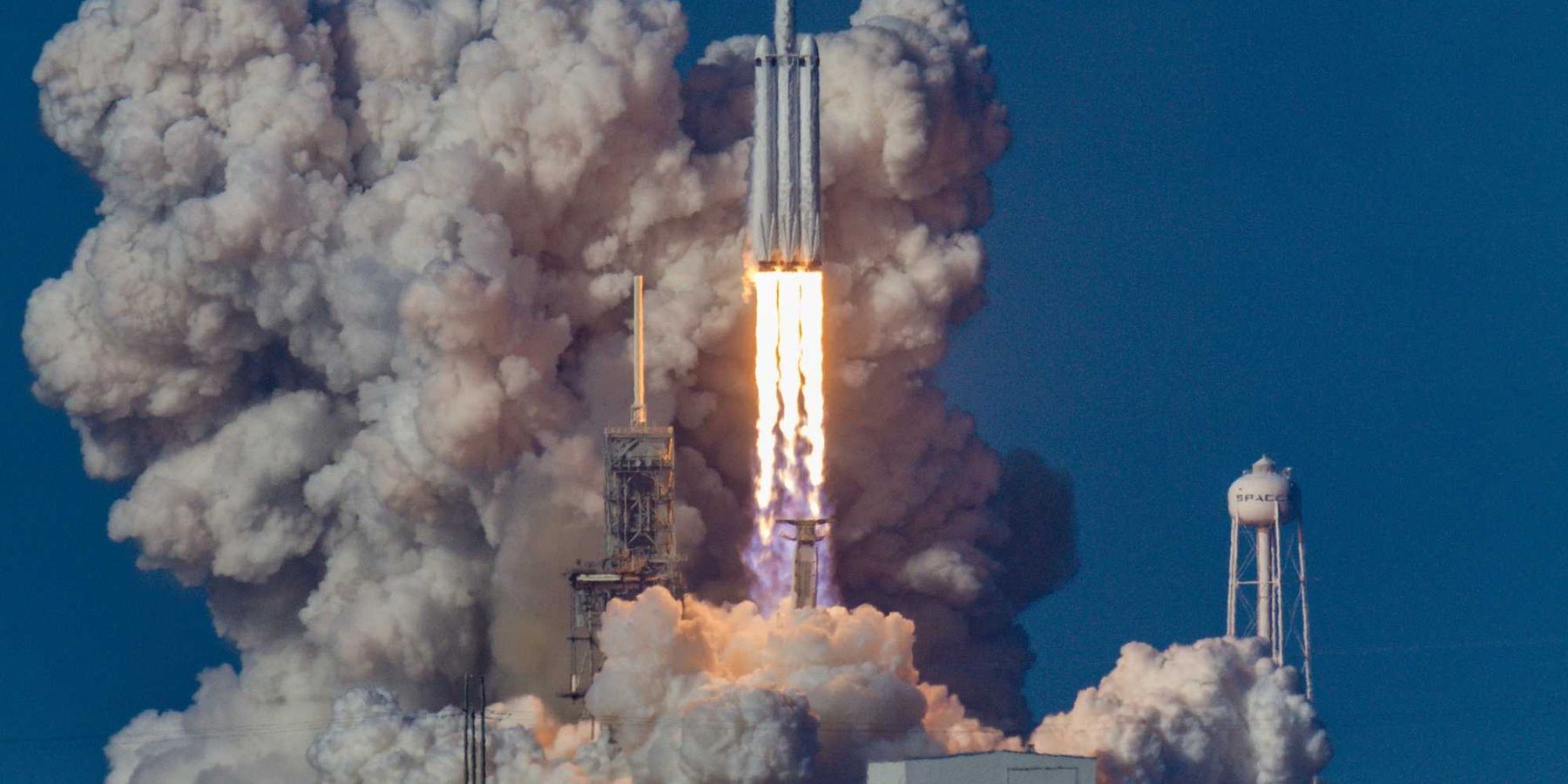 A rocket being launched into space with smoke and flames