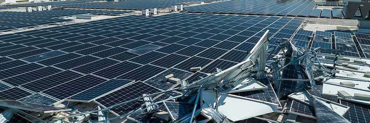 A roof with broken solar panels on it