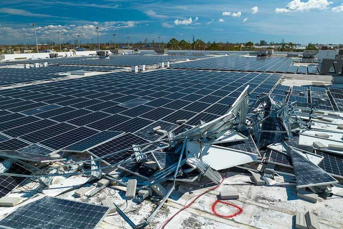 A roof with broken solar panels on it