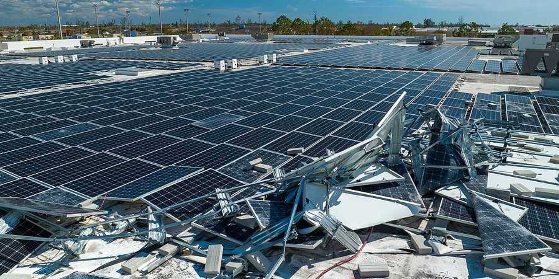A roof with broken solar panels on it