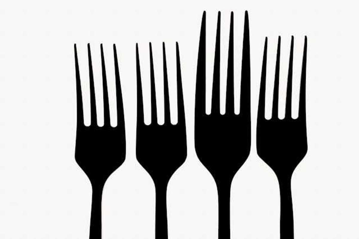 A row of forks against a white background