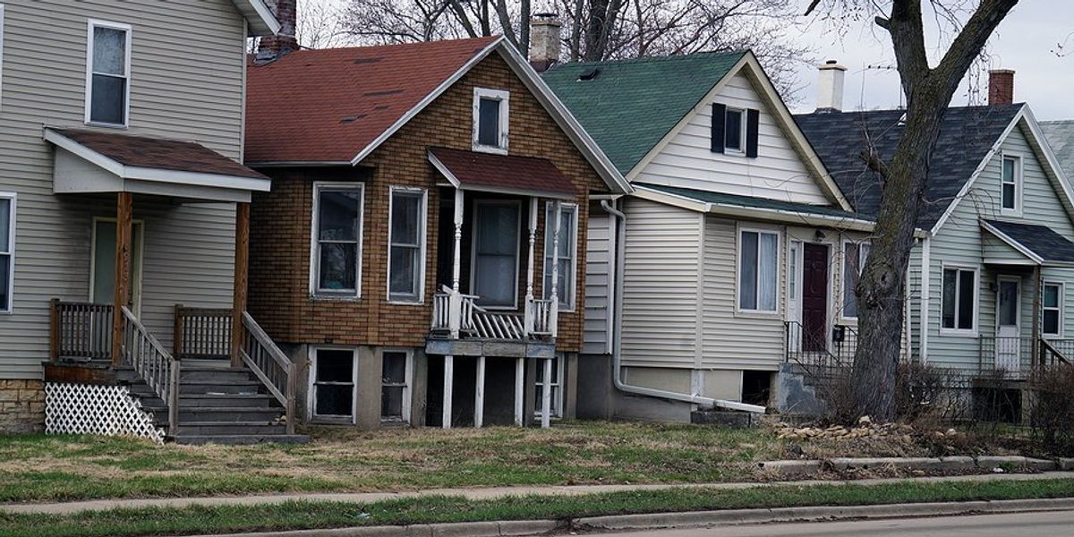 A row of houses on a busy road.