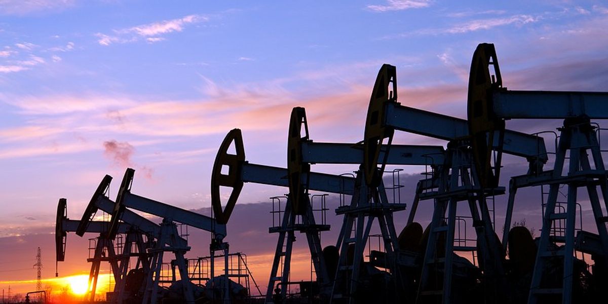 A row of pump jacks stretching into the distance.