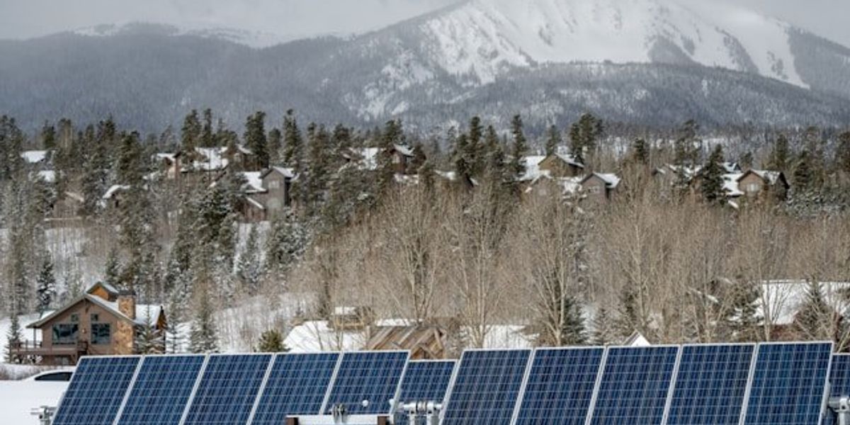 A row of solar panels against a snowy background