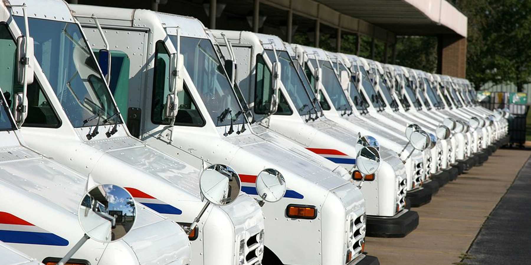 A row of USPS postal vans.