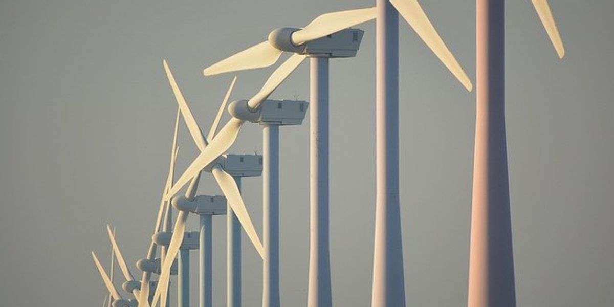 A row of wind turbines stretching into the distance.