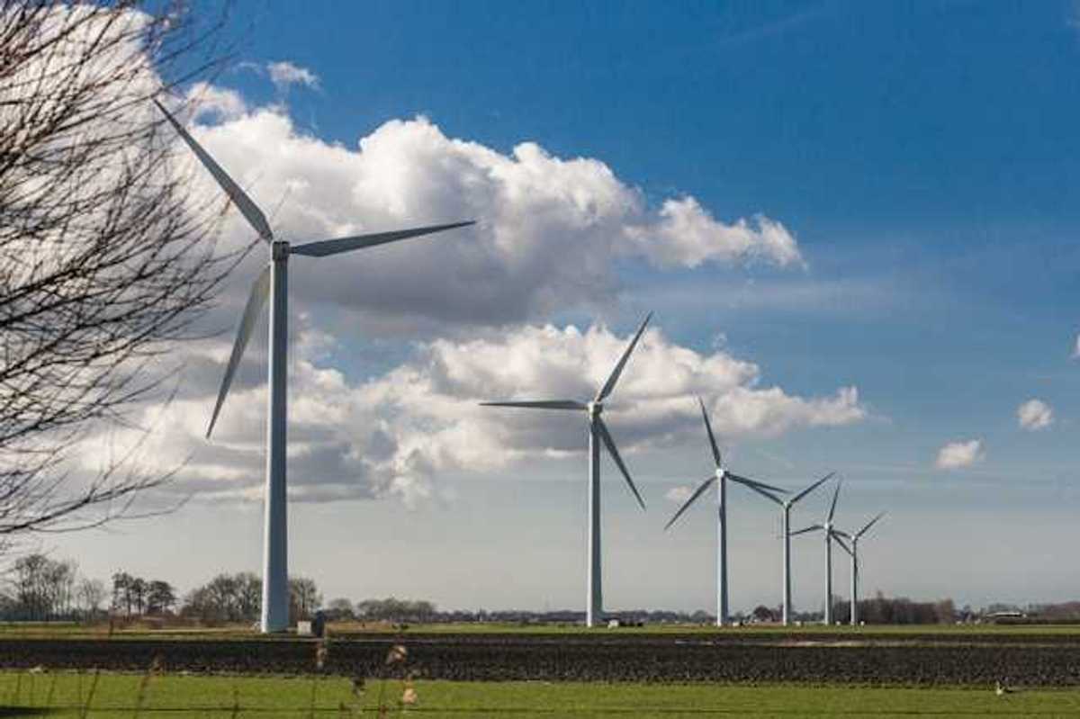 A row of wind turbines stretching into the distance