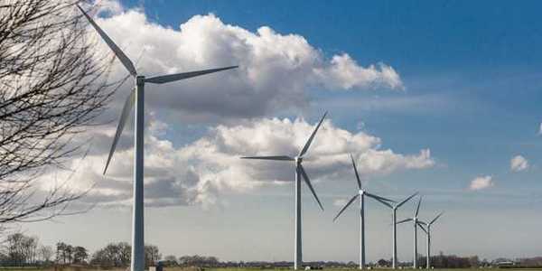 A row of wind turbines stretching into the distance