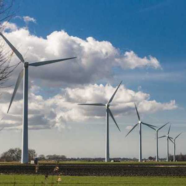 A row of wind turbines stretching into the distance