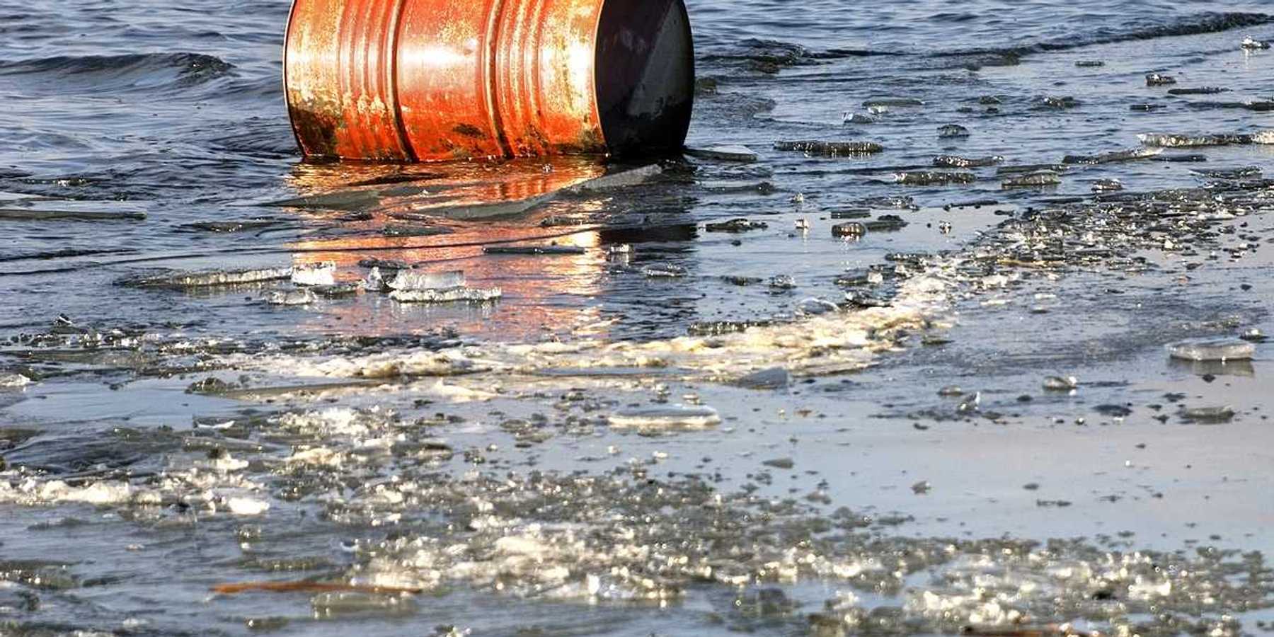 A rusty oil barrel floating in icy water