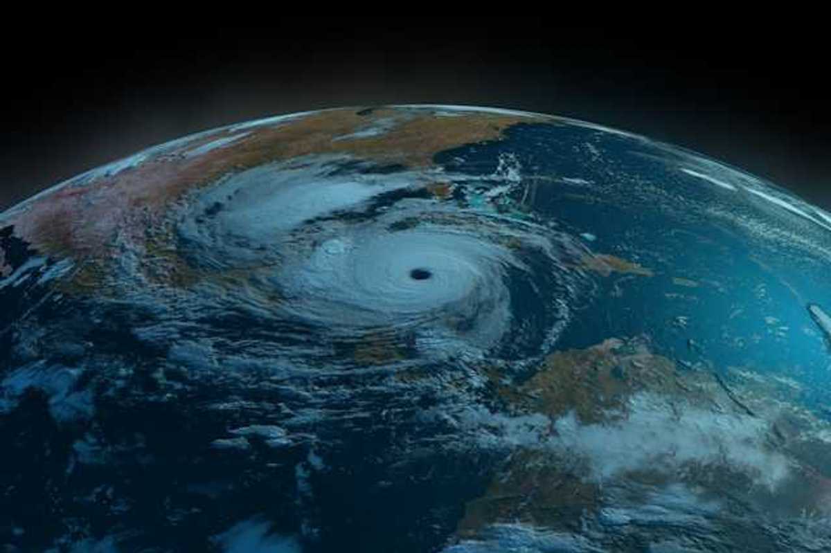 A satellite view of the earth showing a swirling hurricane off the Gulf Coast