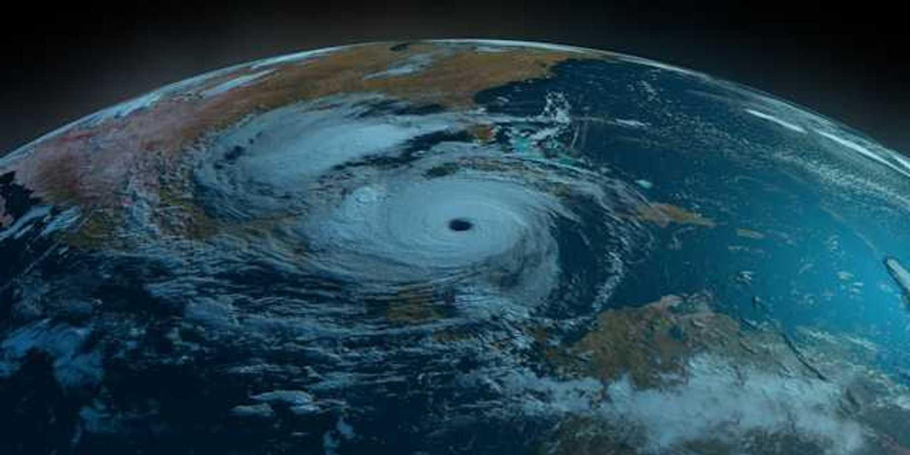 A satellite view of the earth showing a swirling hurricane off the Gulf Coast