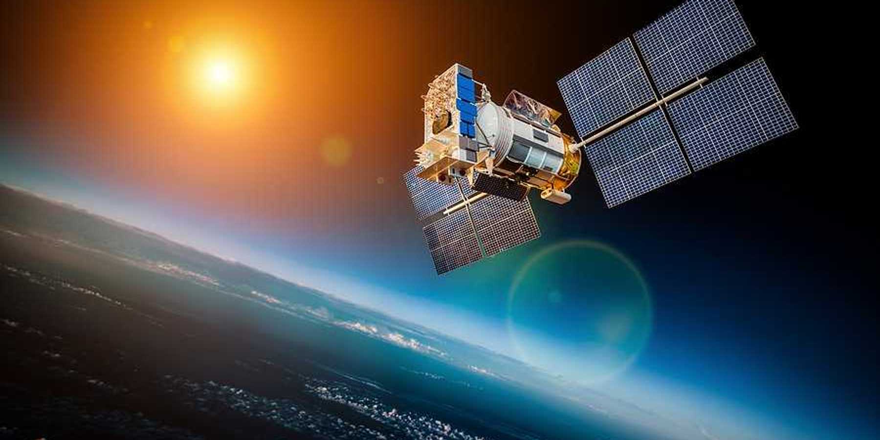 A satellite with the earth and the sun in the background