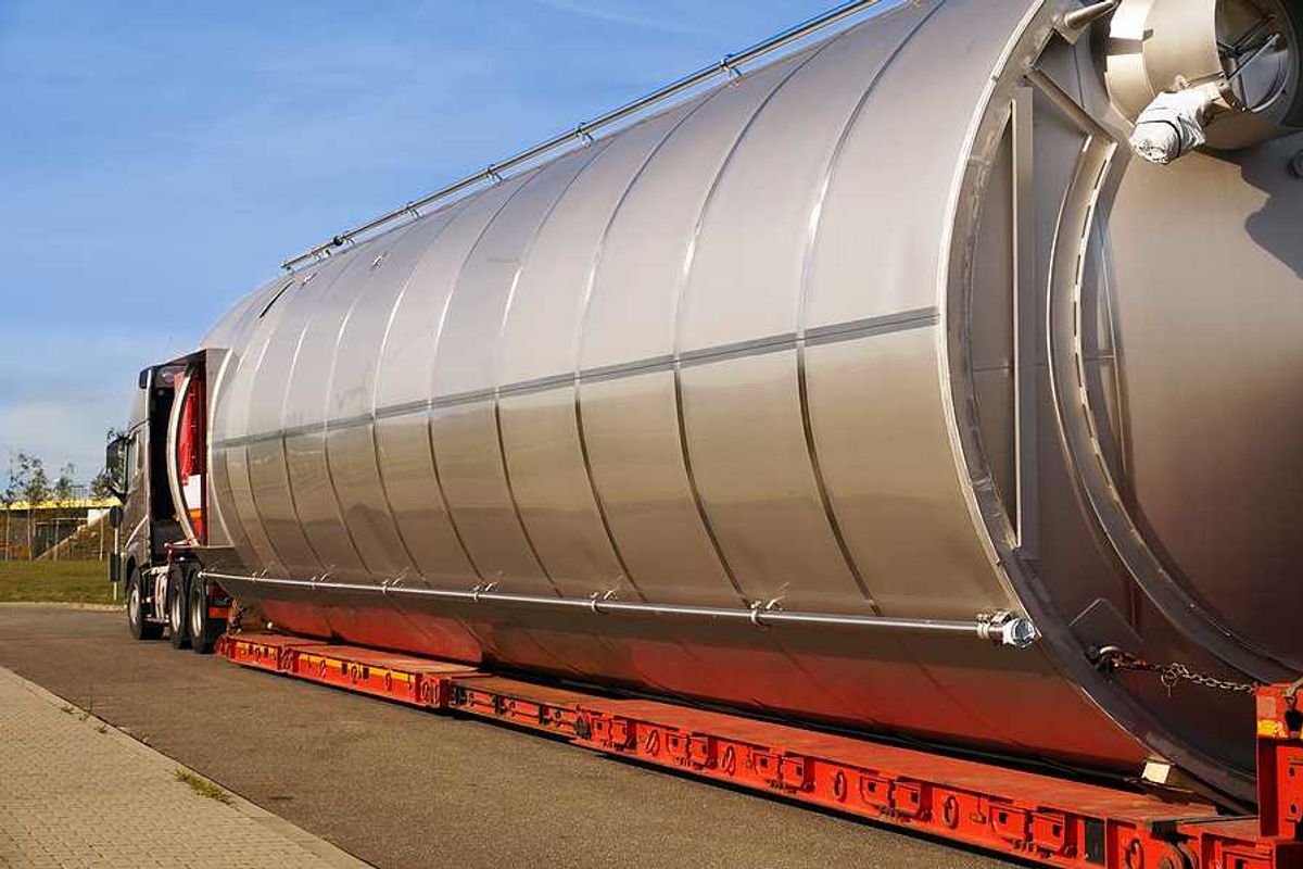 A semi truck hauling a large gas container