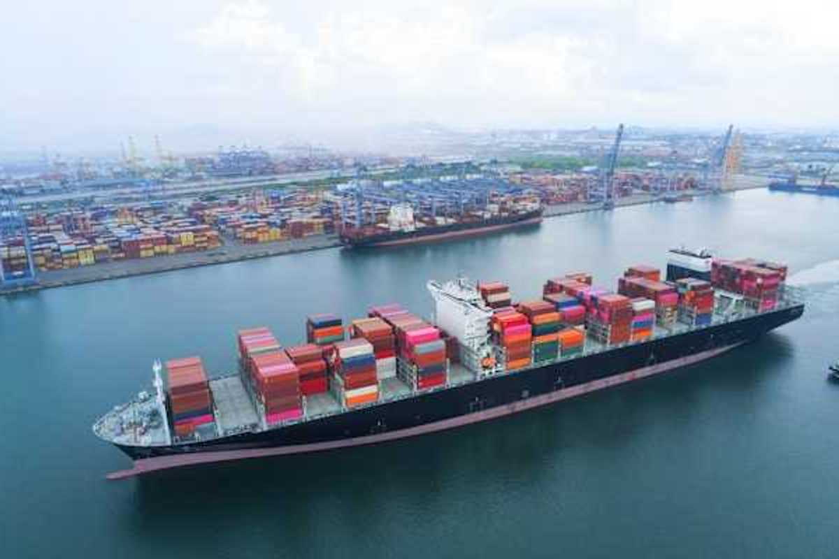 A shipping dock with a loaded tanker floating by