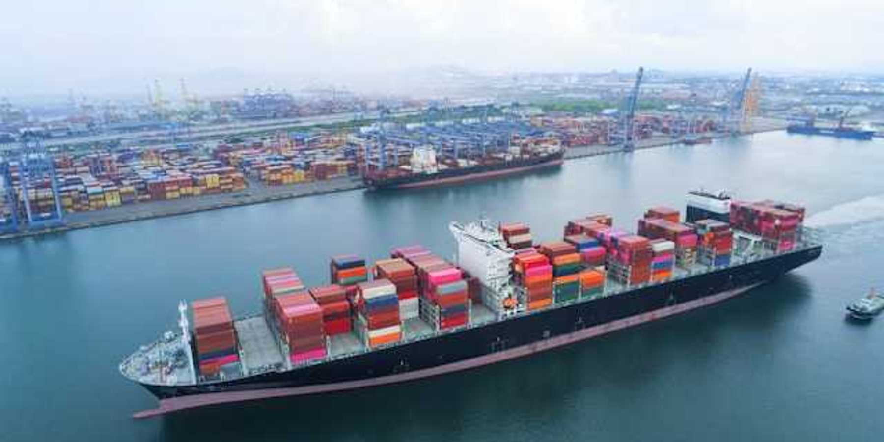 A shipping dock with a loaded tanker floating by