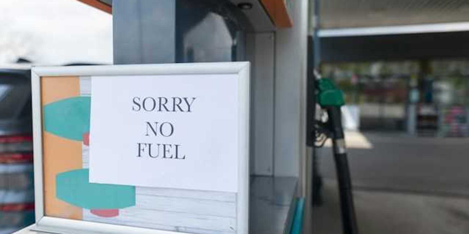A sign that says 'sorry no fuel' next to a gas station pump