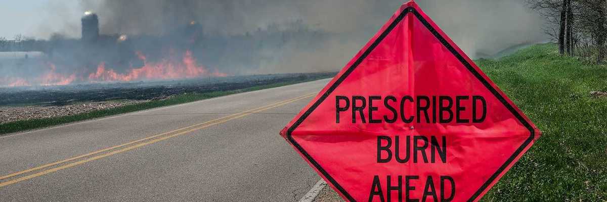 A sign warns motorists of a controlled burn area ahead on a farm in southern Wisconsin.