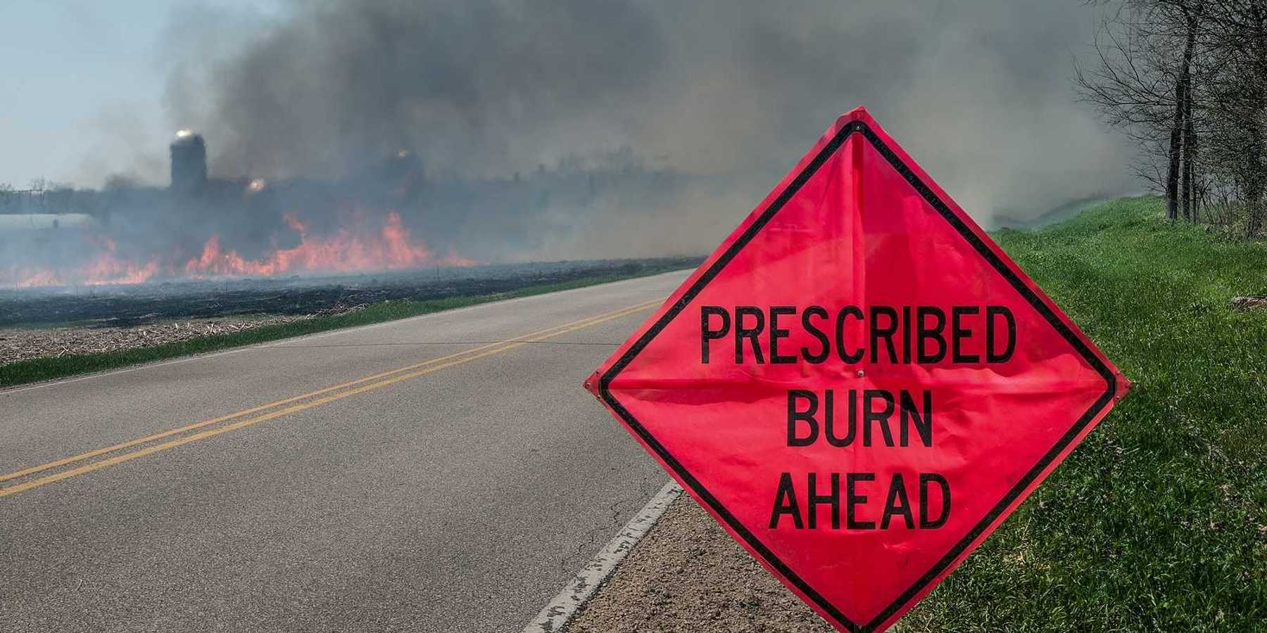 A sign warns motorists of a controlled burn area ahead on a farm in southern Wisconsin.