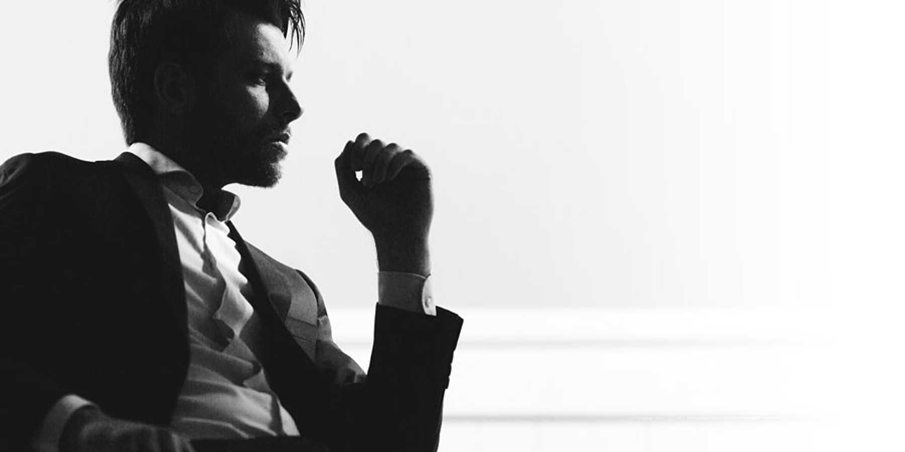 A silhouette of a businessman sitting in a chair.