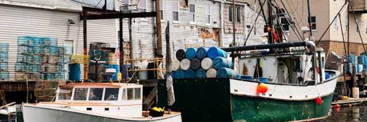 A small harbor with older fishing boats at a dock