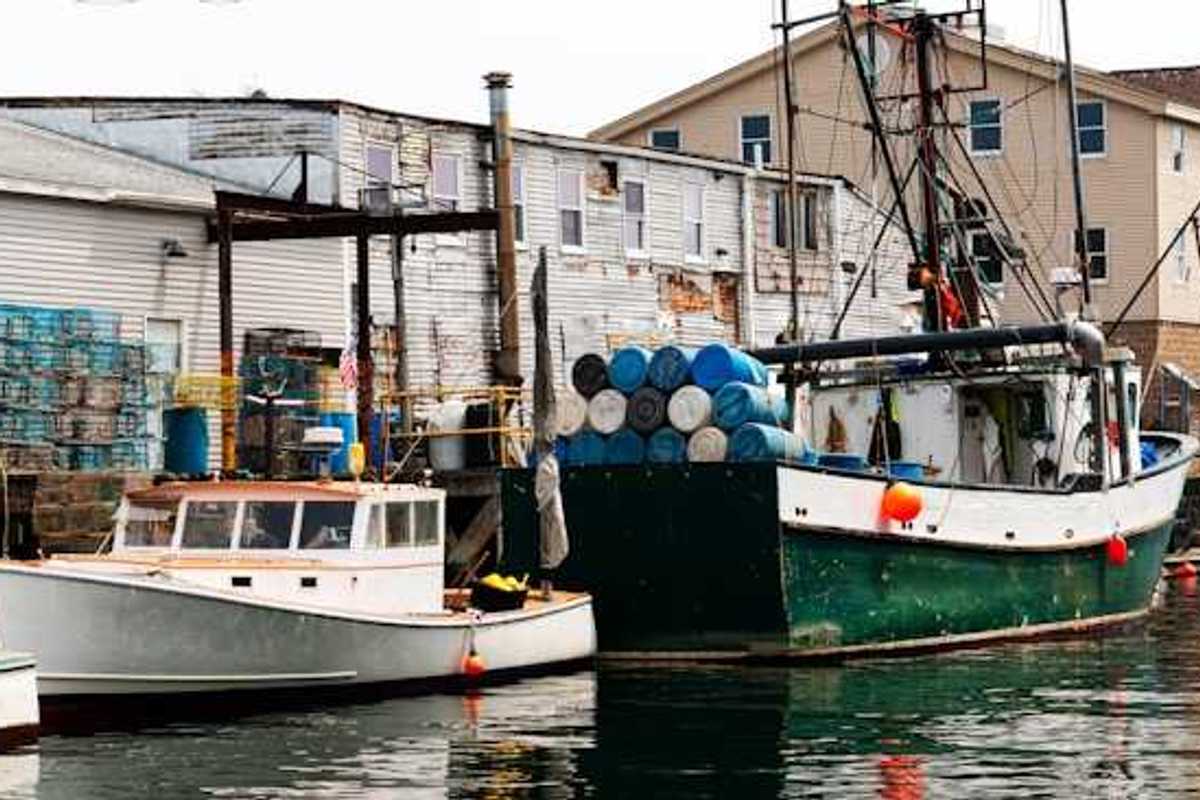 A small harbor with older fishing boats at a dock