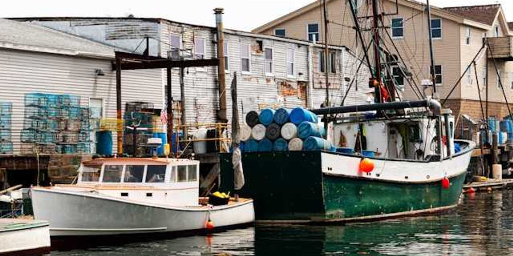 A small harbor with older fishing boats at a dock