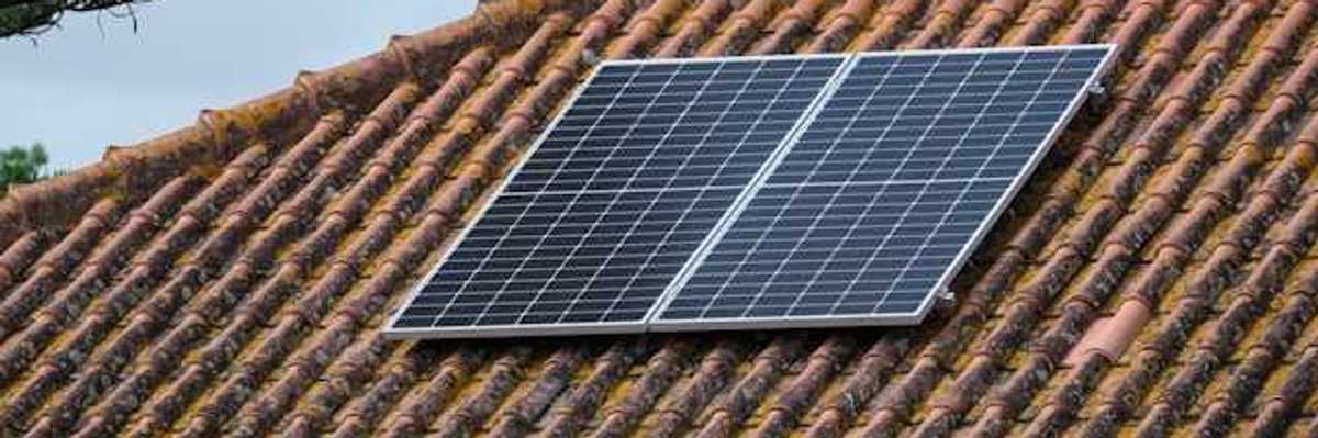 A small rooftop solar panel on a tiled roof